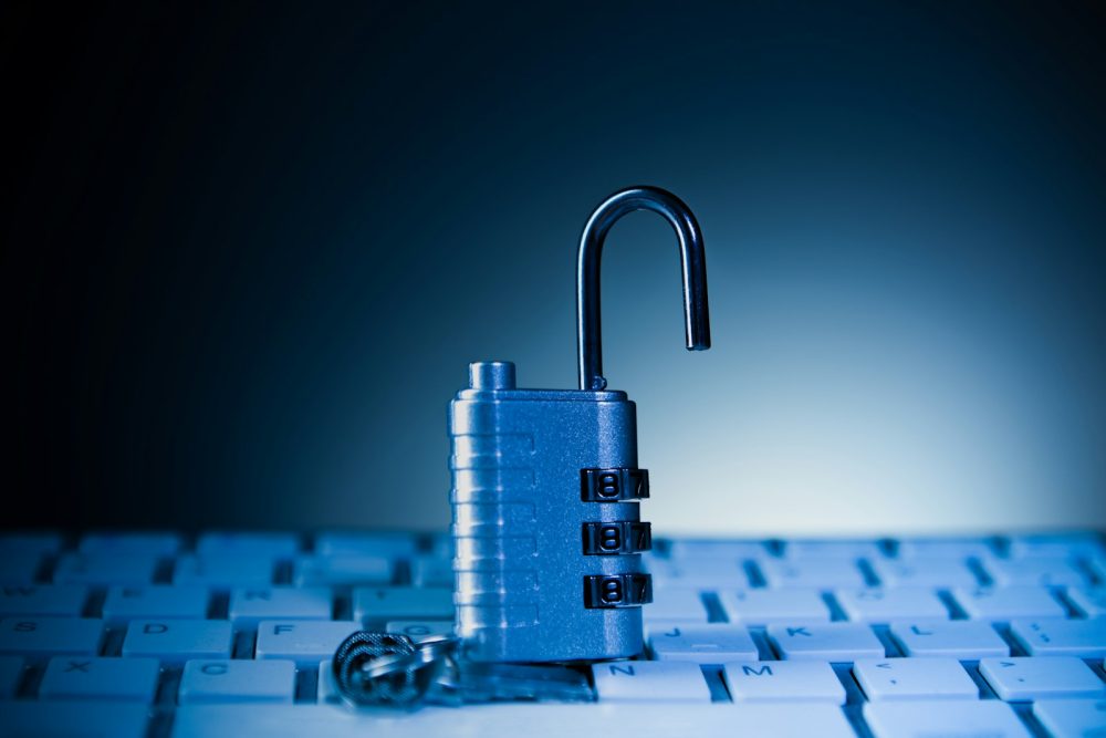 An unlocked padlock resting on a keyboard
